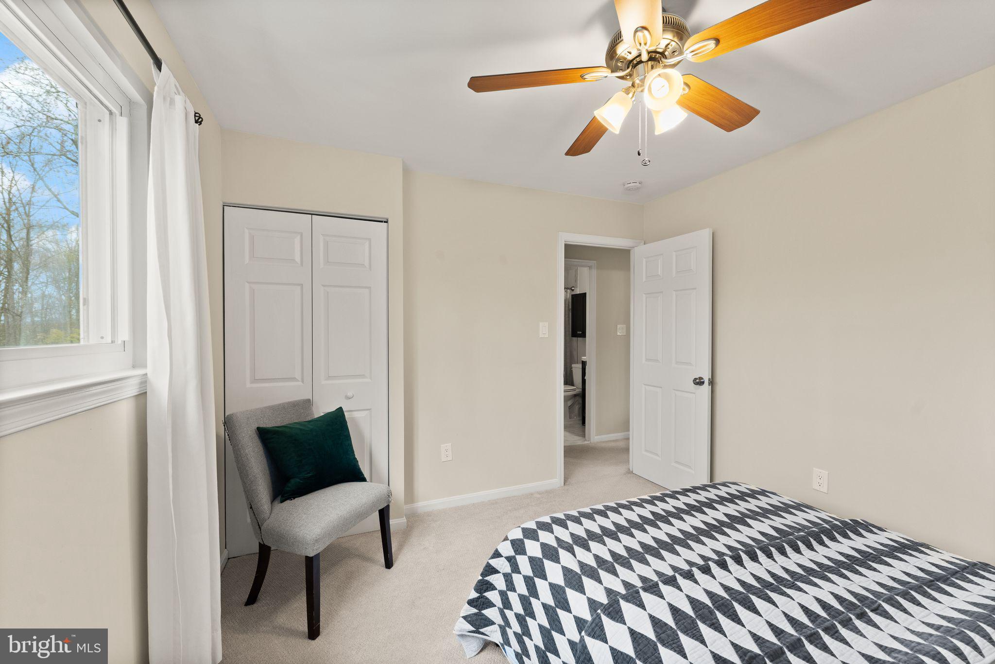 2412 Ivywood Road Reston, VA 20191 - Photo 37 of 63 a bedroom with a bed and a chandelier