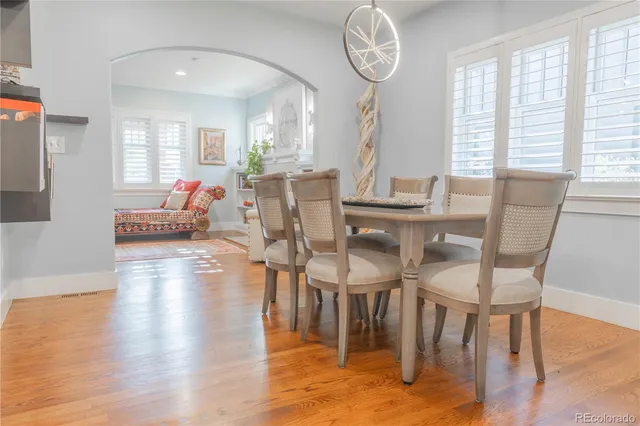 a view of a dining room with furniture window and wooden floor