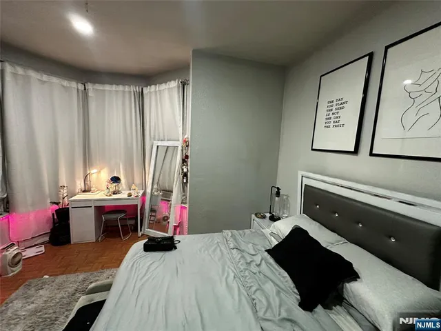a bed room with a bed and a chair
