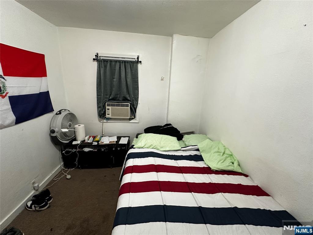 366 Summer Avenue Newark, NJ 07104 - Photo 12 of 22 a bedroom with a bed and wooden floor