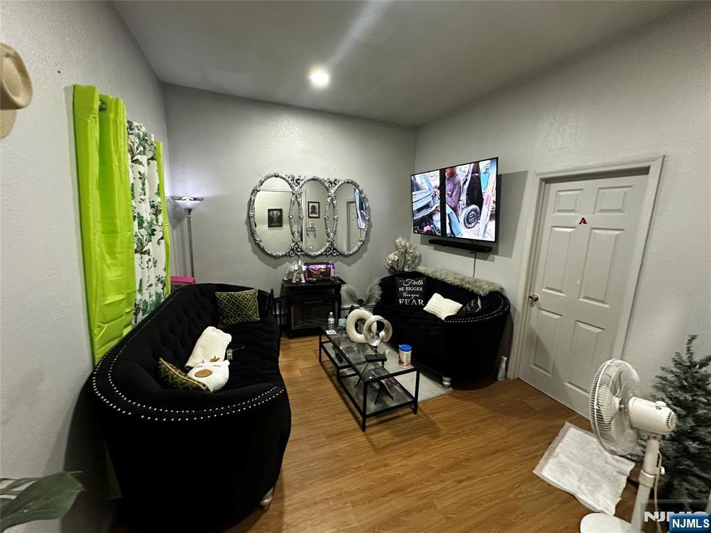 366 Summer Avenue Newark, NJ 07104 - Photo 2 of 22 a living room with furniture and a mirror