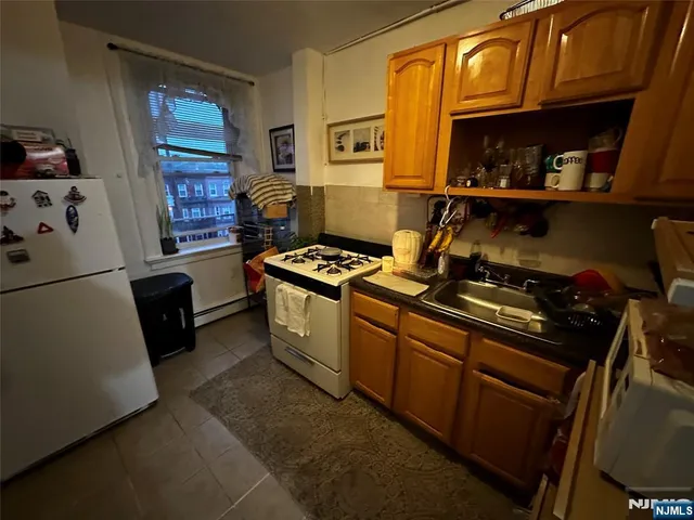 a kitchen with stainless steel appliances granite countertop a stove and a refrigerator