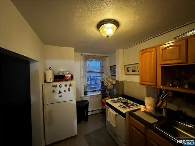 a kitchen with a refrigerator stove and microwave