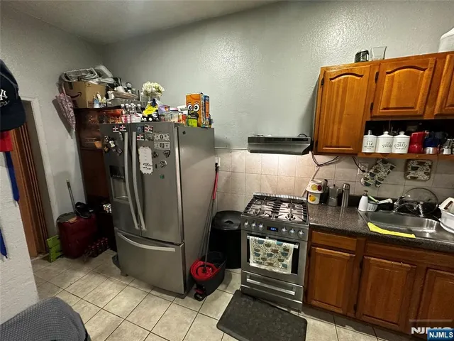 a kitchen with stainless steel appliances granite countertop a sink and cabinets