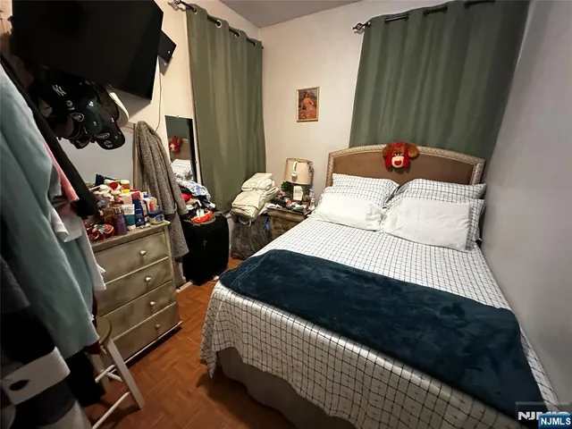 a bedroom with a bed dresser and a window