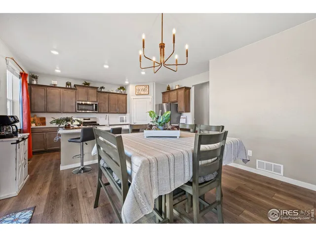 a view of a dining room with furniture and a chandelier