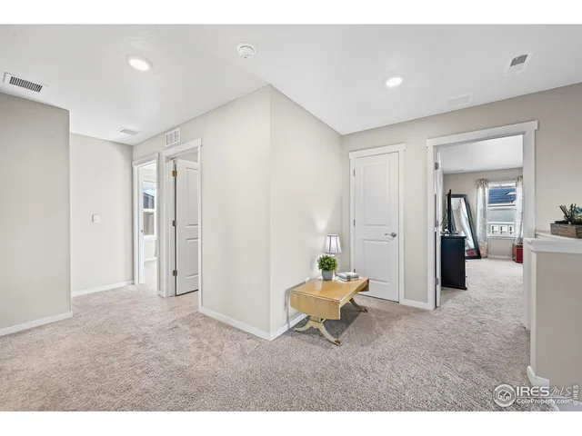 a living room with furniture and a dining table