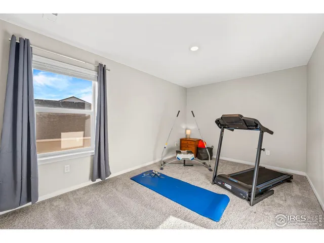 a bedroom with furniture and wooden floor
