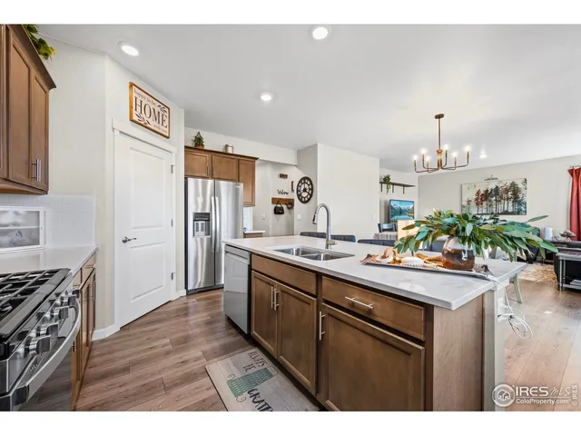 a kitchen with stainless steel appliances a sink stove and refrigerator
