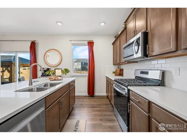 a kitchen with stainless steel appliances granite countertop a sink and stove