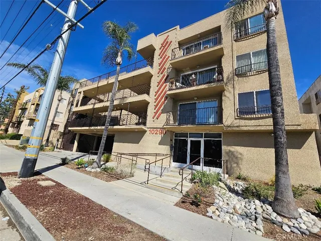 an empty room & kitchen space with a sink