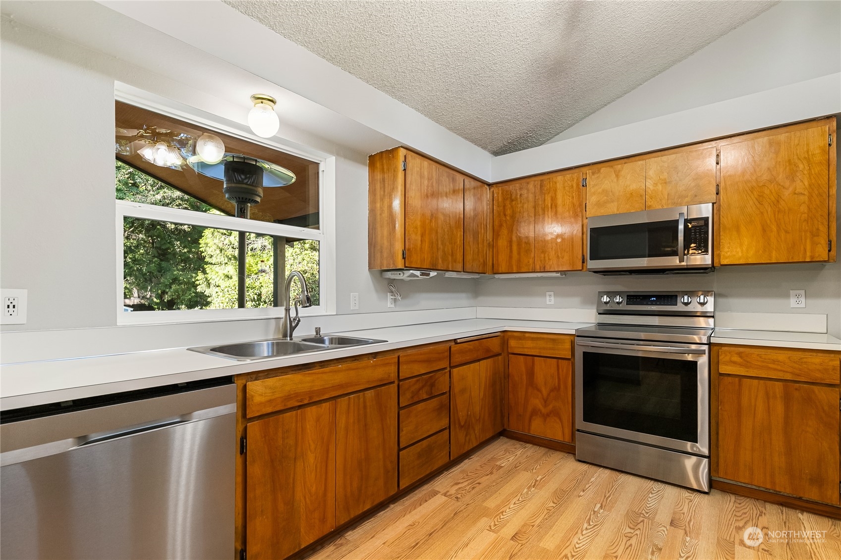 5917 Longdin Road Ferndale, WA 98248 - Photo 12 of 36 a kitchen with stainless steel appliances granite countertop a sink stove and microwave