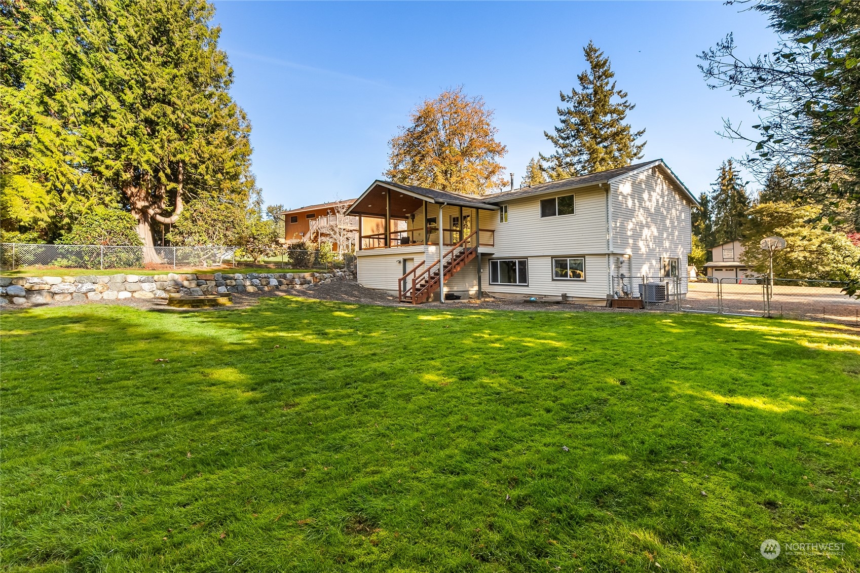 5917 Longdin Road Ferndale, WA 98248 - Photo 31 of 36 a view of a house with a big yard and large trees