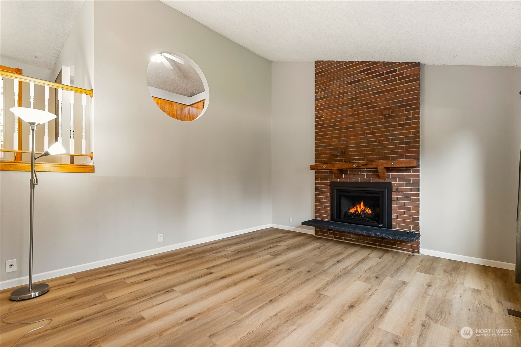 5917 Longdin Road Ferndale, WA 98248 - Photo 5 of 36 an empty room with wooden floor a fireplace and window