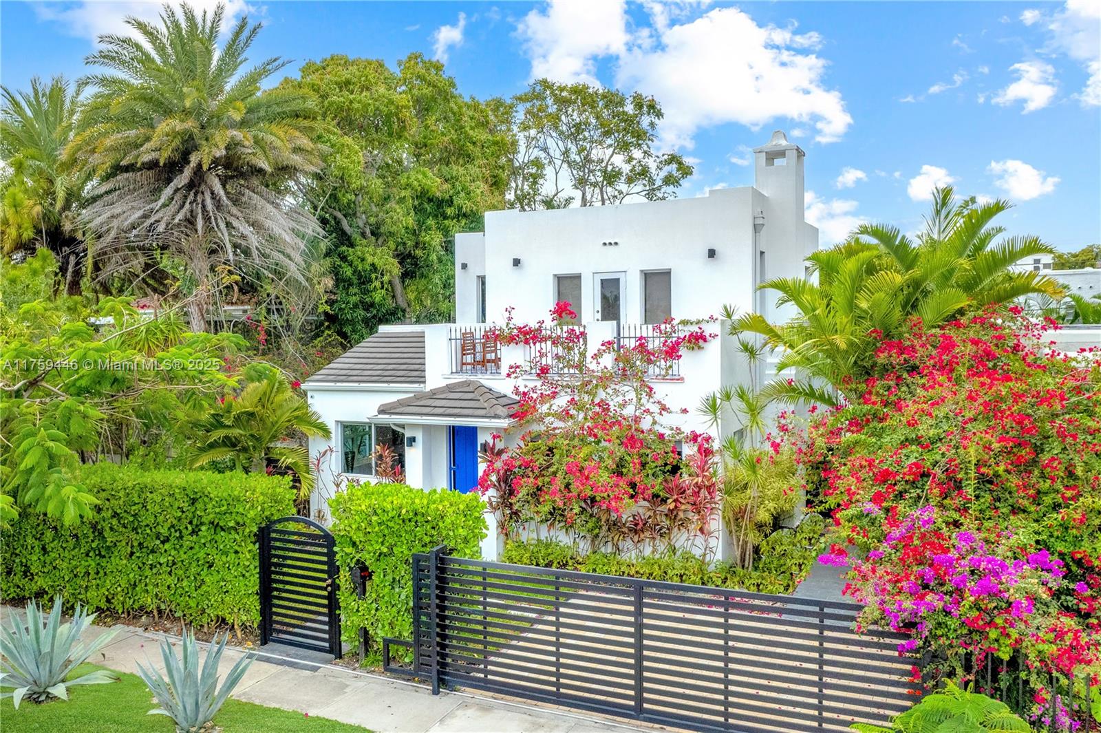 a front view of a house with a flower garden