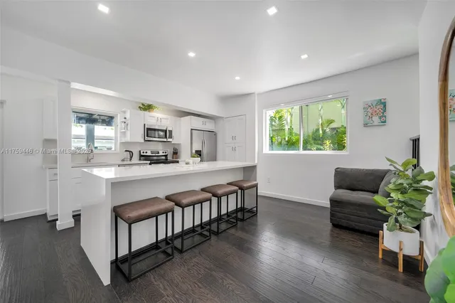 a living room with furniture a window and a chandelier