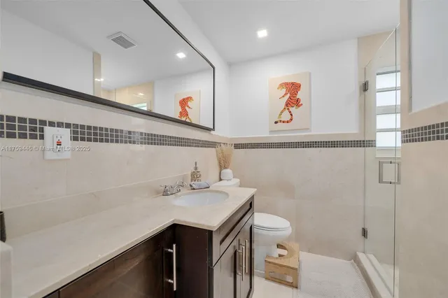 a living room with furniture wooden floor and a flat screen tv