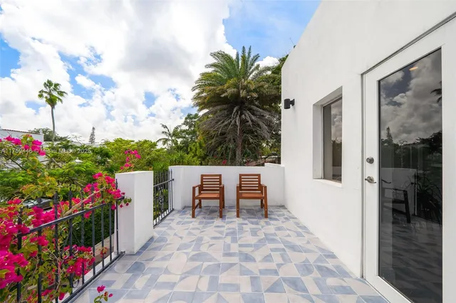 a view of a patio with glass top table and chairs
