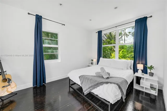 a bedroom with furniture and a potted plant