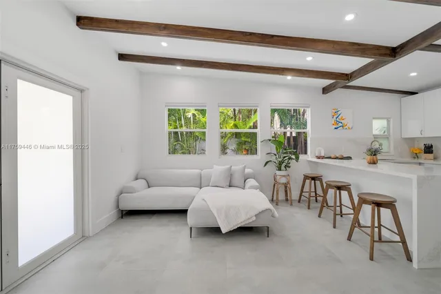 a kitchen with refrigerator a table and chairs