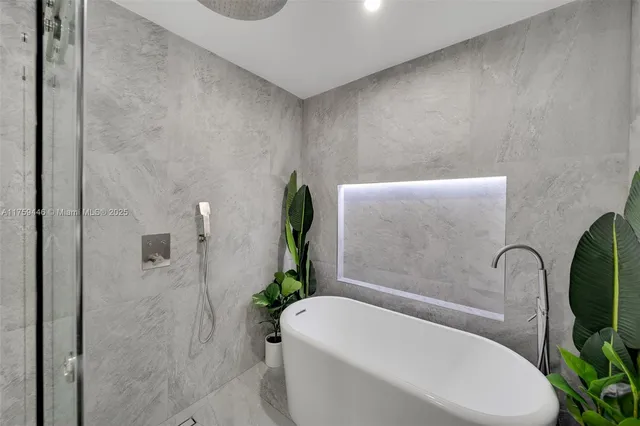 a white bath tub sitting in a bathroom