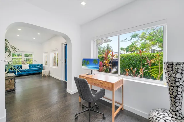 a living room with furniture fireplace and a window
