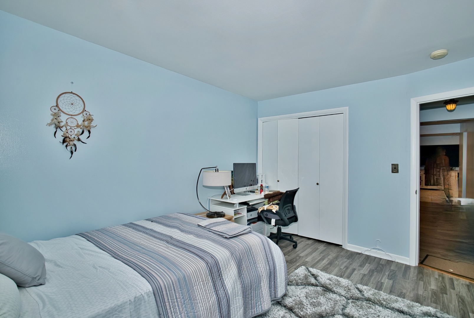 1428 West Fargo Avenue, Unit 303 Chicago, IL 60626 - Photo 23 of 28 a bedroom with a bed and a chandelier