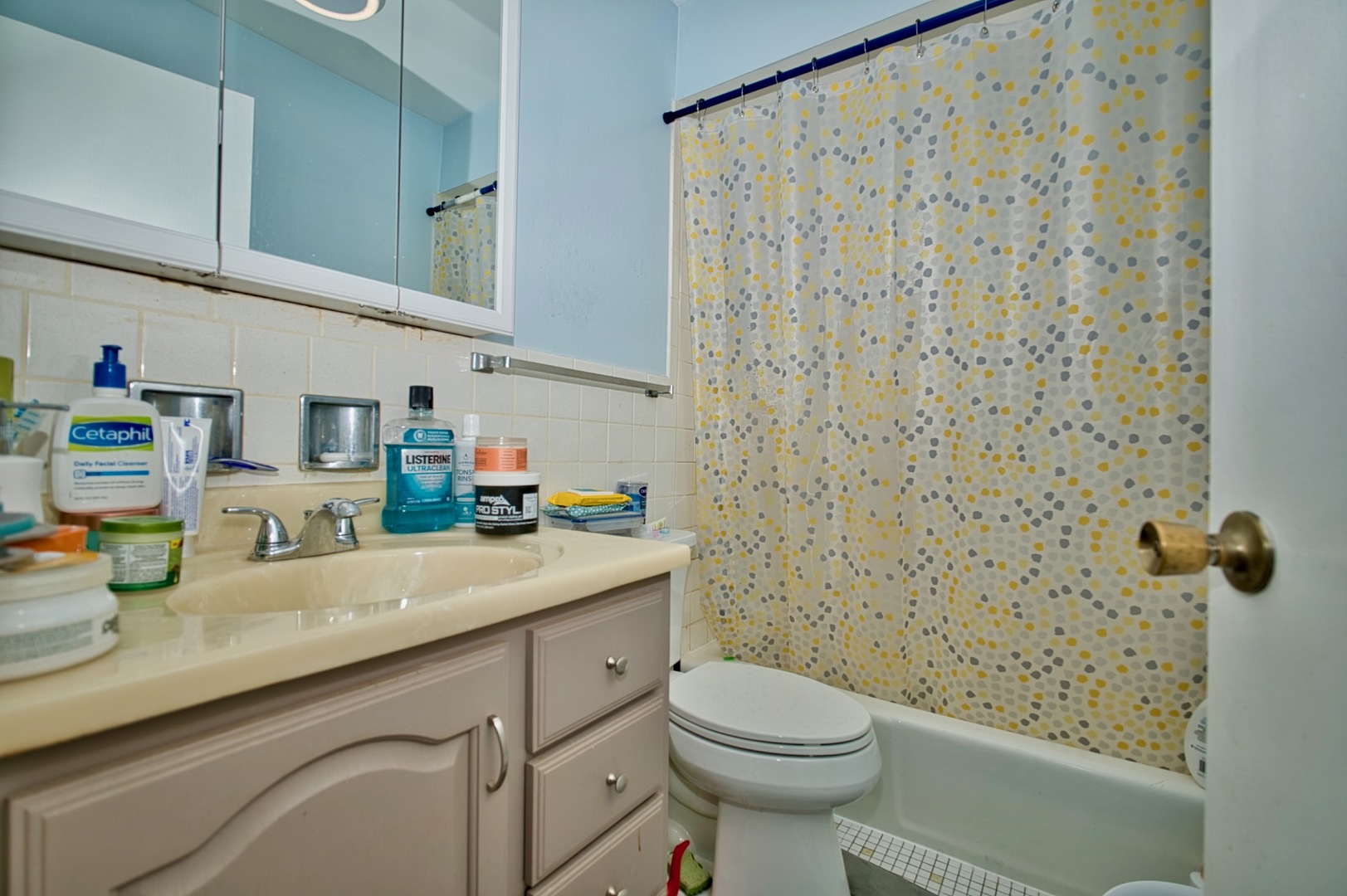 1428 West Fargo Avenue, Unit 303 Chicago, IL 60626 - Photo 24 of 28 a bathroom with a sink a toilet and shower curtain
