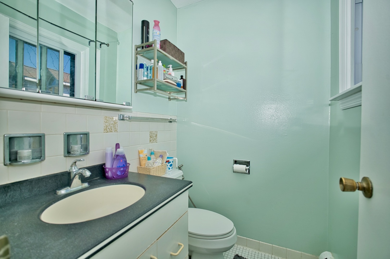 1428 West Fargo Avenue, Unit 303 Chicago, IL 60626 - Photo 28 of 28 a bathroom with a toilet a sink and mirror