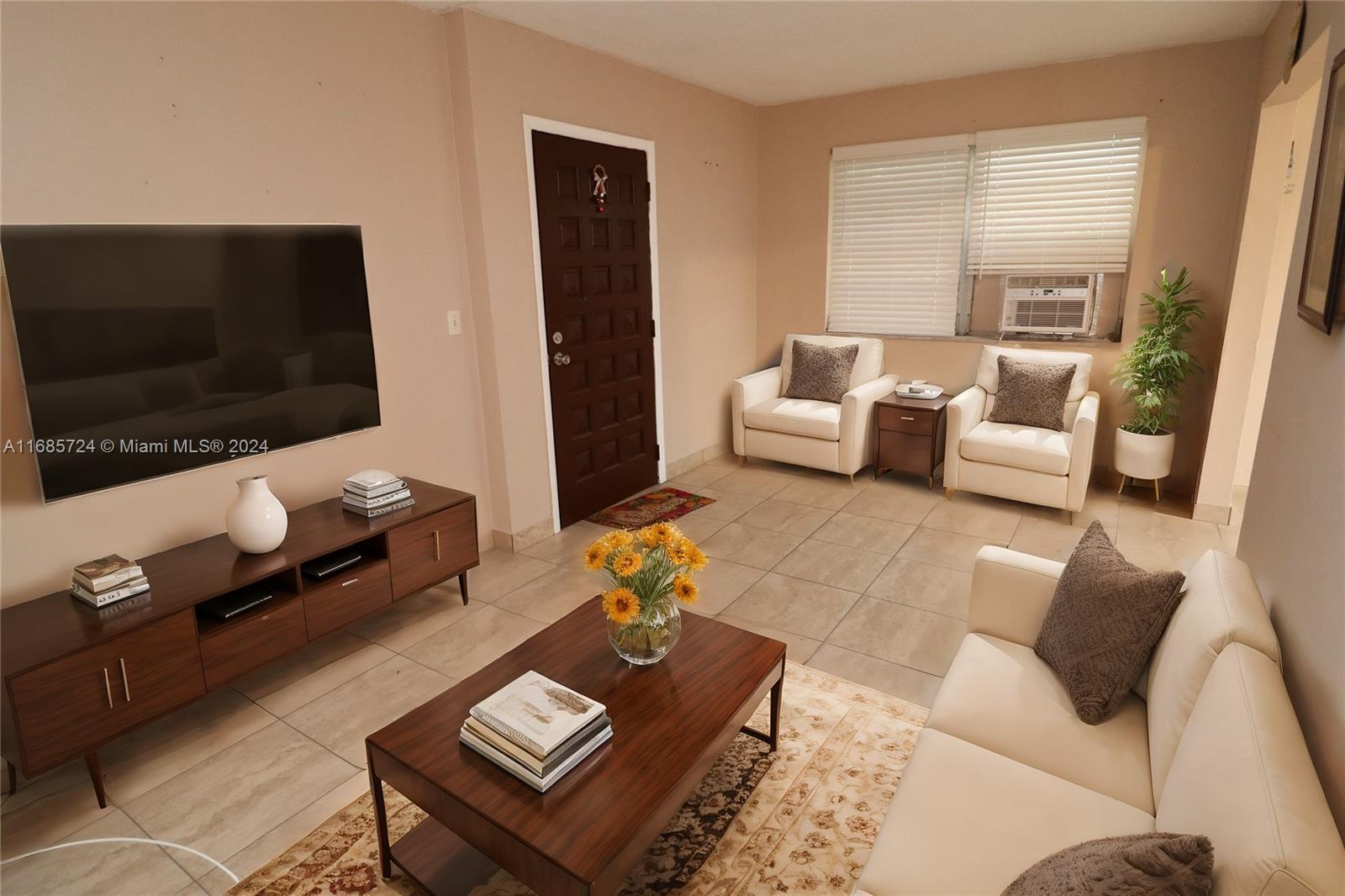 1828 Northwest 19th Street, Unit 4 Miami, FL 33125 - Photo 1 of 22 a living room with furniture and a flat screen tv