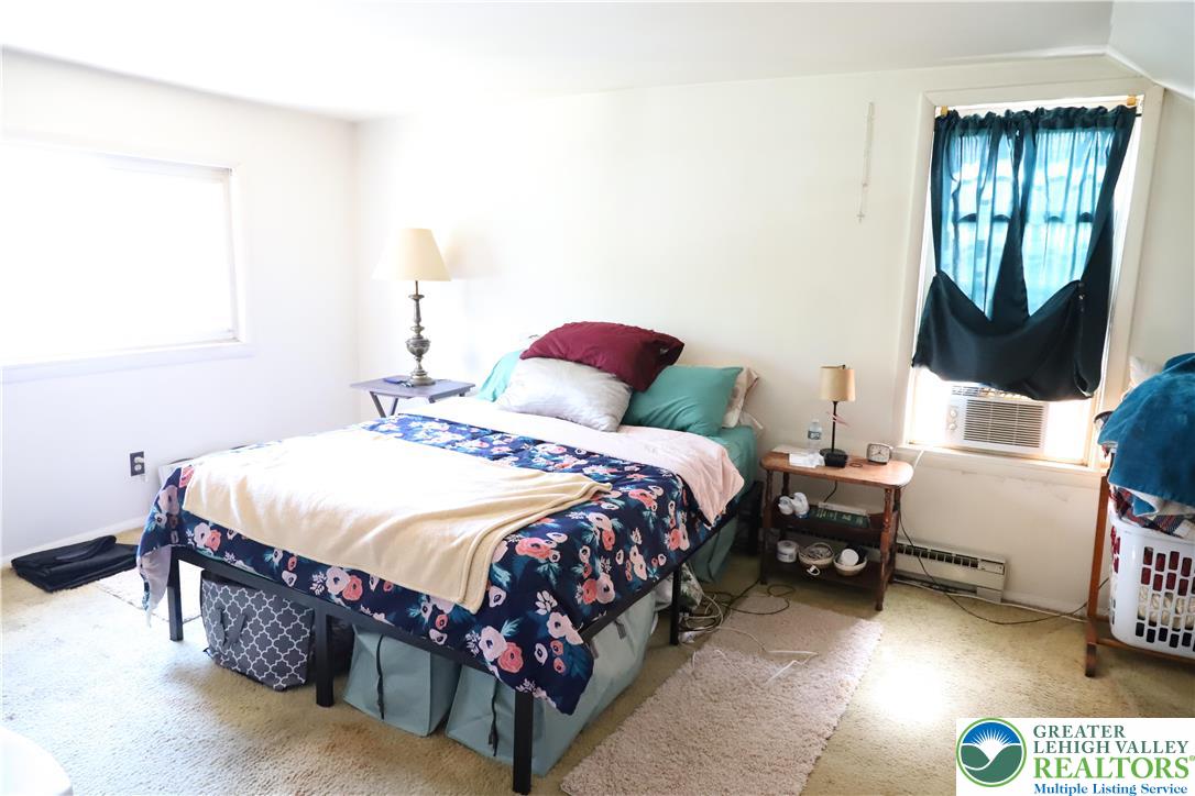 820 Walton Street Bethlehem, PA 18018 - Photo 12 of 18 a bedroom with a bed mirror and window