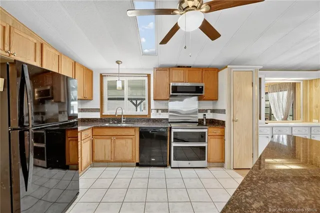 a kitchen with stainless steel appliances granite countertop a refrigerator and a stove top oven