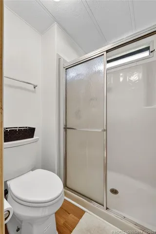 a bathroom with a toilet and a shower