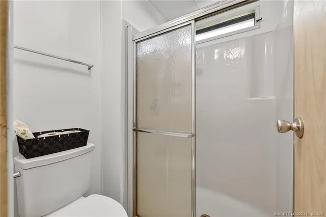 a bathroom with a toilet and a shower