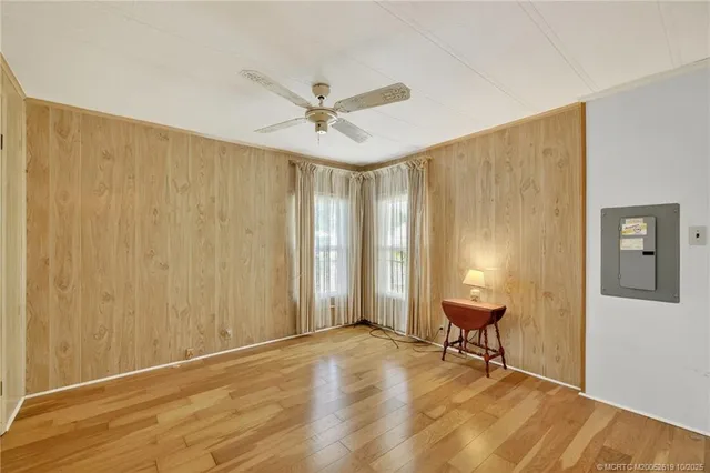 a view of a workspace with wooden floor and a window