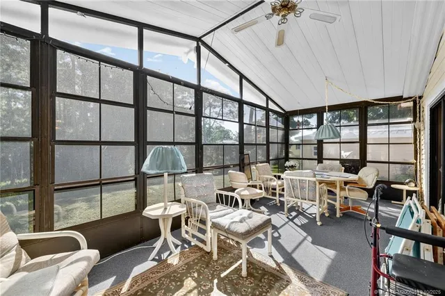 a living room with lots of furniture and a large window