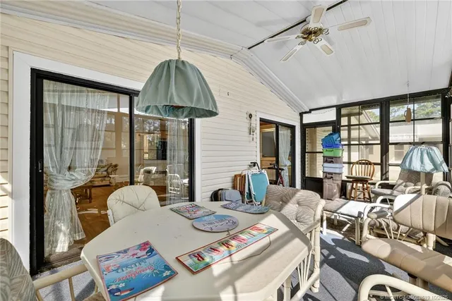 a living room with furniture a flat screen tv and a large window