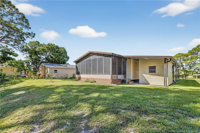 a view of a house with backyard and garden