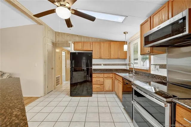 a kitchen with a sink stainless steel appliances and cabinets