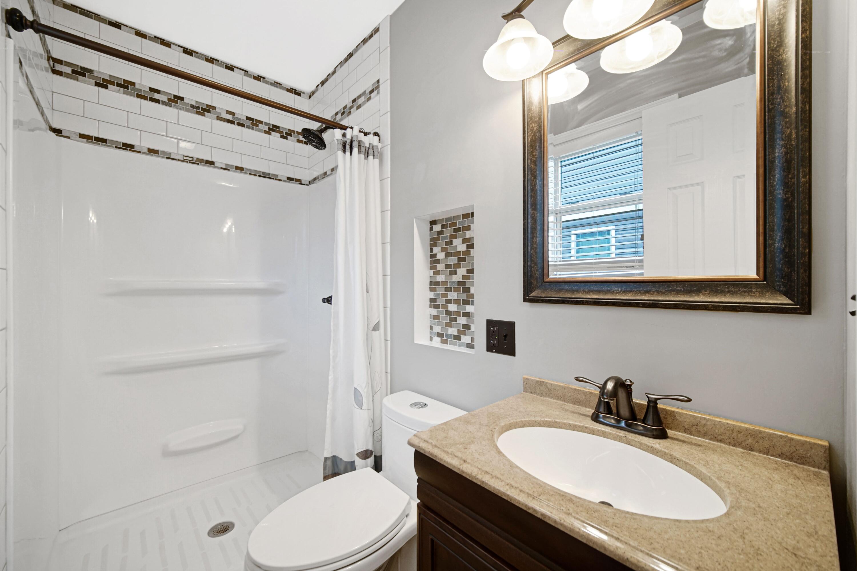 1441 Brandywine Road Crown Point, IN 46307 - Photo 12 of 24 a bathroom with a sink toilet a mirror and shower