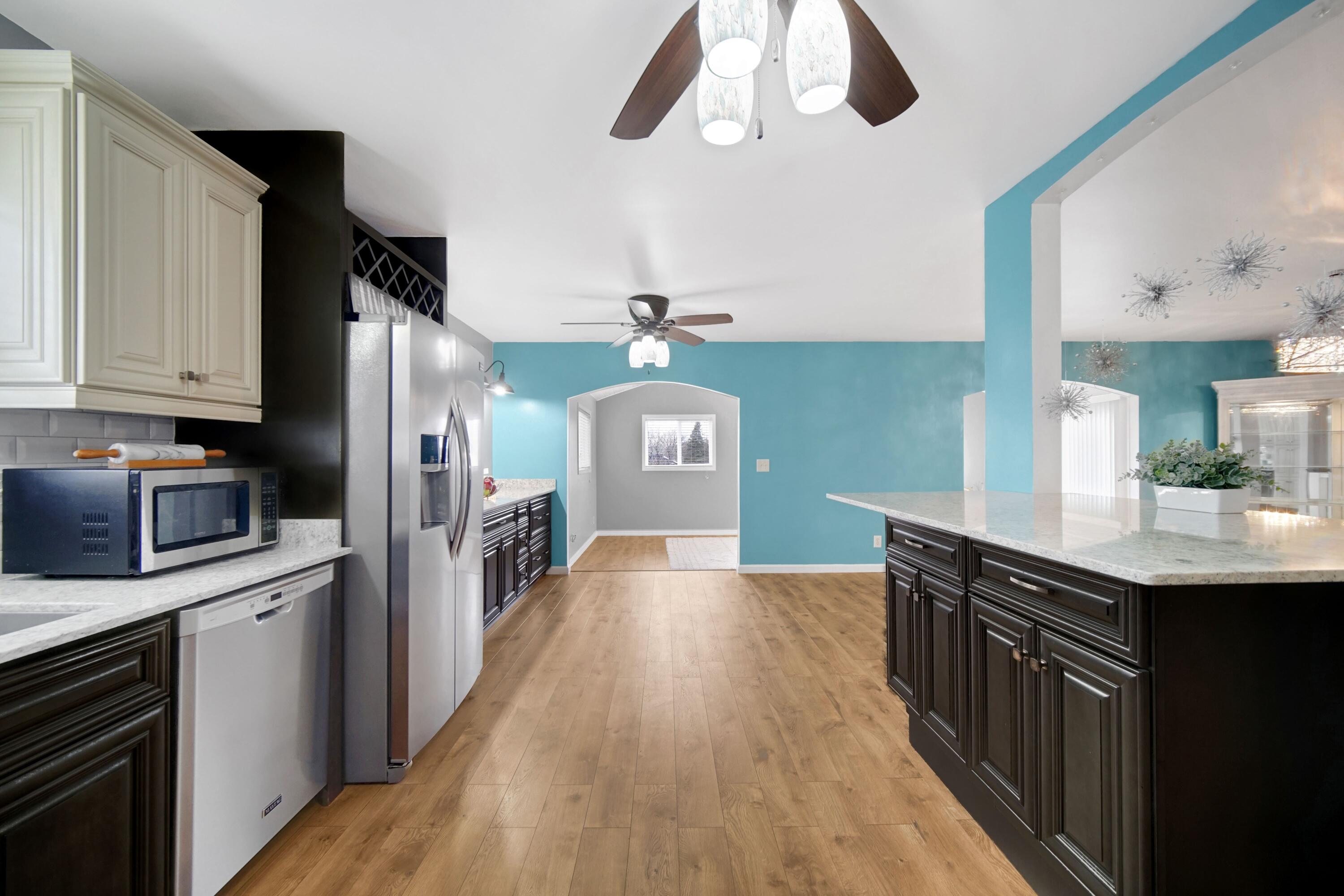1441 Brandywine Road Crown Point, IN 46307 - Photo 8 of 24 a kitchen with stainless steel appliances a kitchen island wooden floors and stove