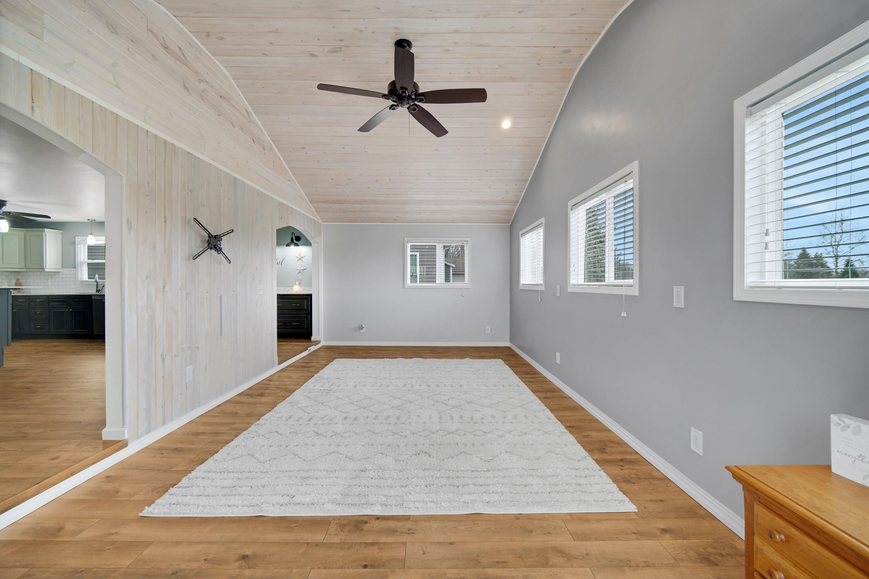 1441 Brandywine Road Crown Point, IN 46307 - Photo 10 of 24 a view of a livingroom with a ceiling fan and wooden floor