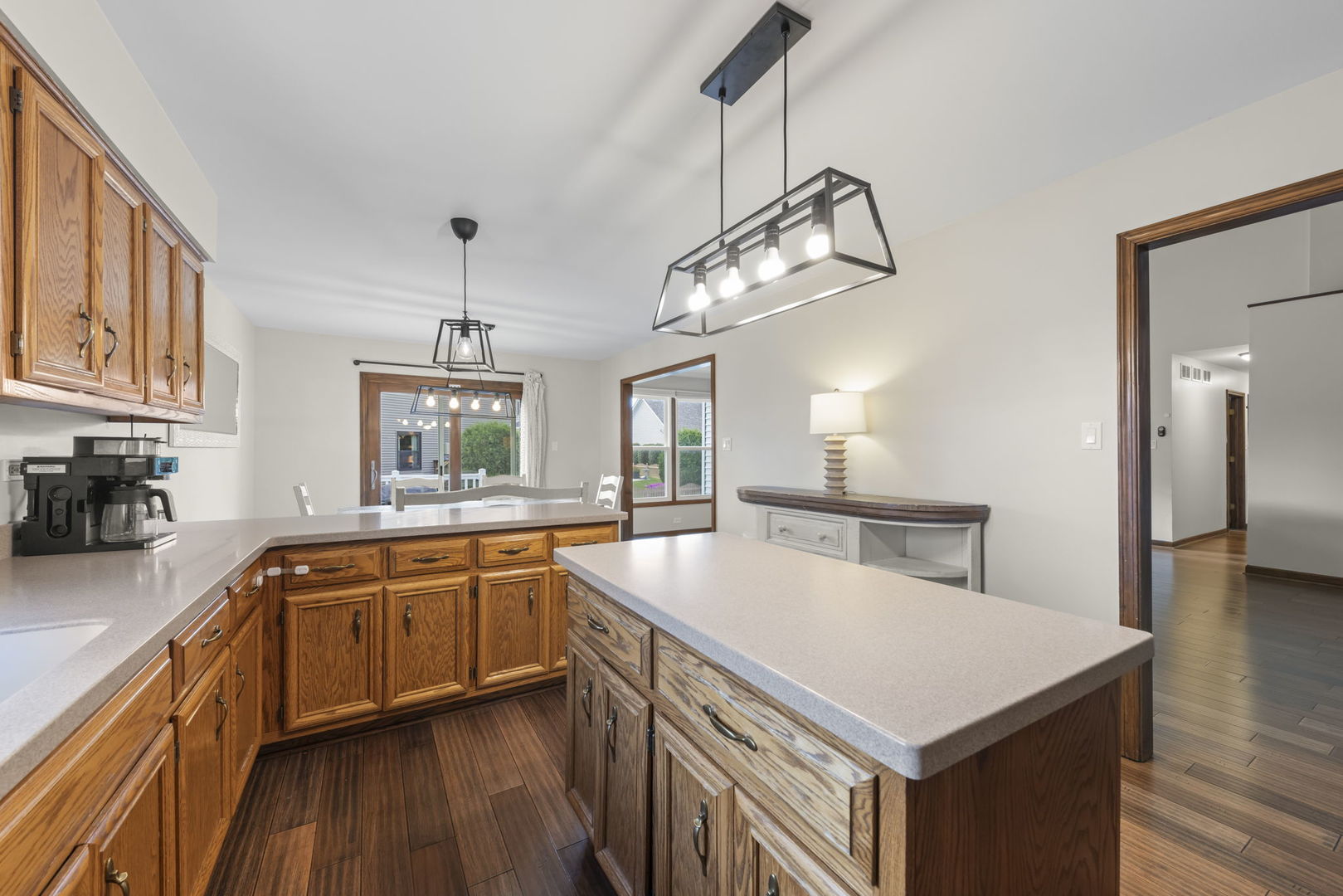 1801 Chestnut Hill Road Plainfield, IL 60586 - Photo 8 of 24 a kitchen with a stove a sink dishwasher a kitchen island with wooden cabinets and floor