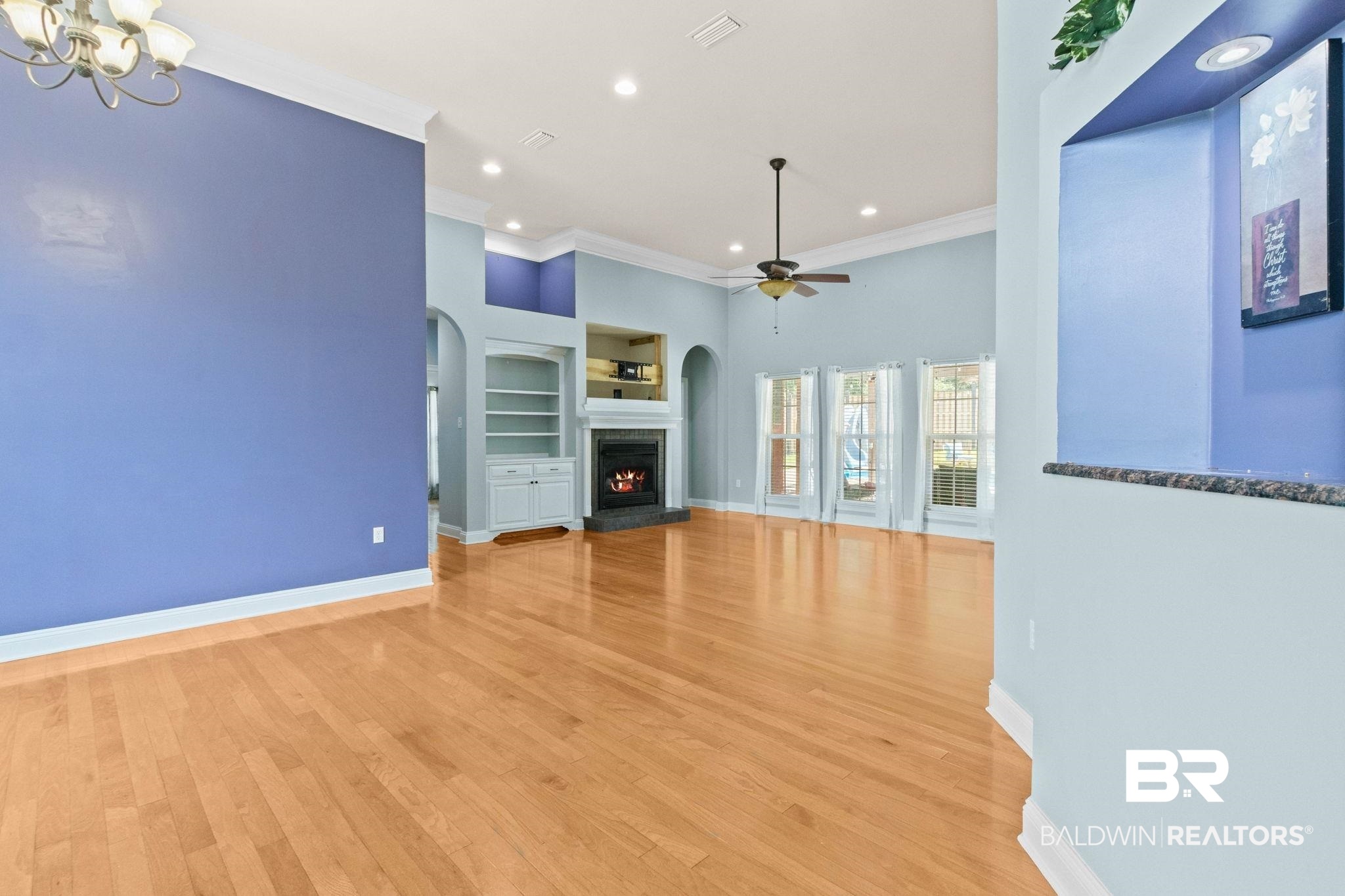 79 Whitetail Run Chatom, AL 36518 - Photo 13 of 82 Spacious living area featuring light wood-finish flooring, a contemporary ceiling fan, and recessed lighting