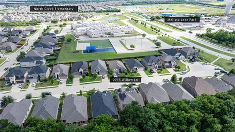 an aerial view of multiple houses with yard