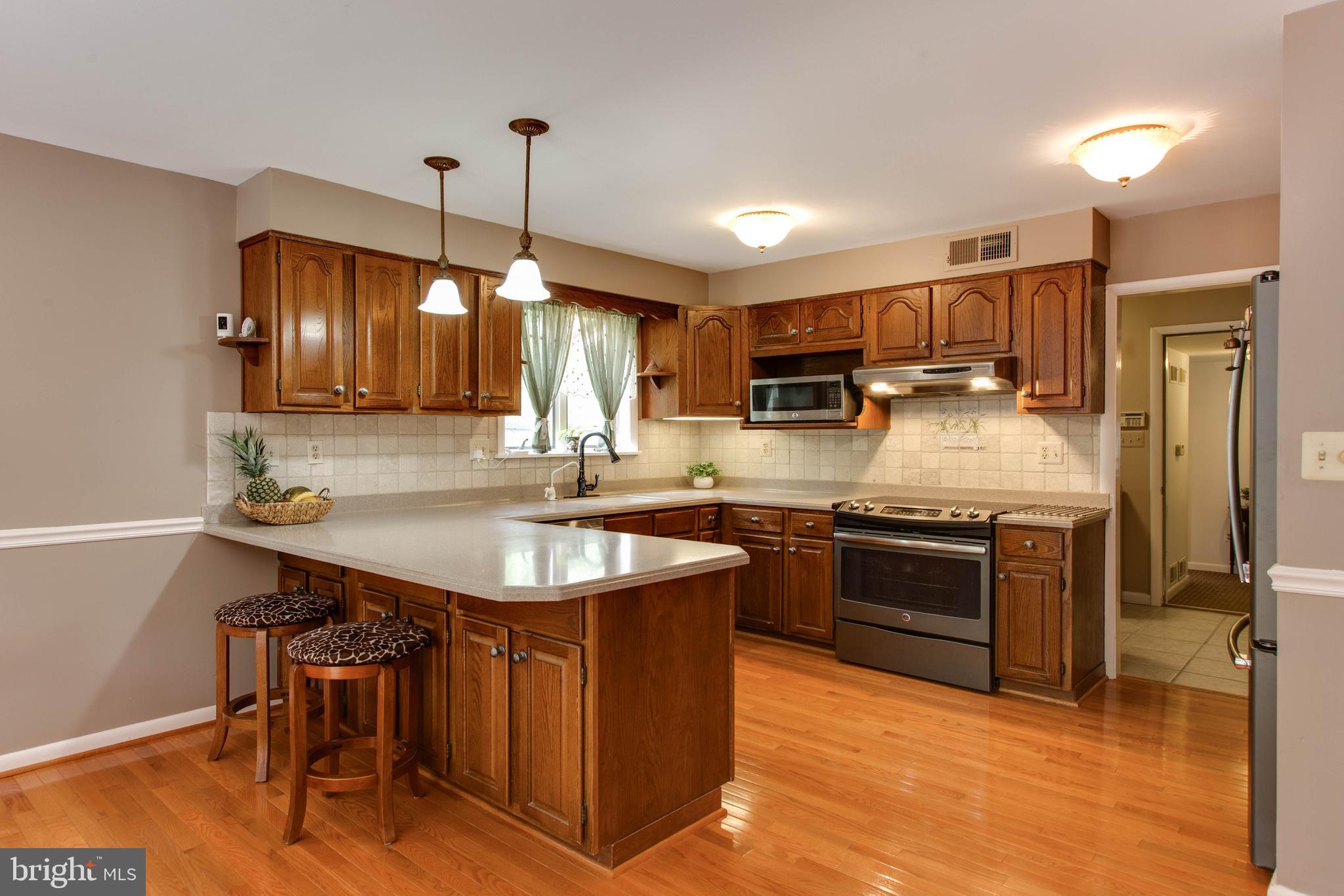 5519 Woodbine Road Sykesville, MD 21784 - Photo 17 of 69 a kitchen with stainless steel appliances granite countertop a sink a stove and a refrigerator