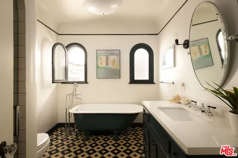 a bathroom with a sink toilet and mirror