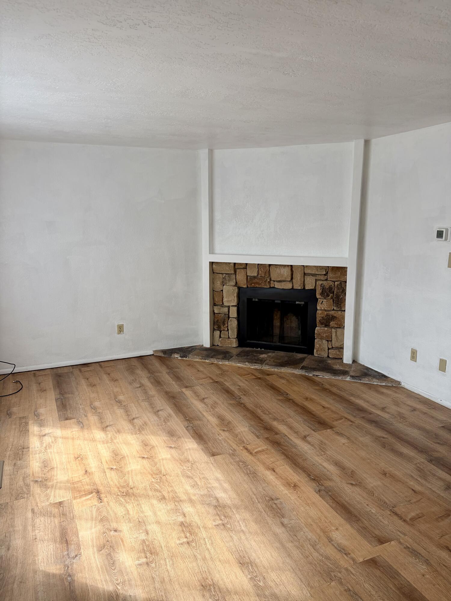 1198 Morrow Road, Unit A Medford, OR 97504 - Photo 2 of 20 a view of empty room with a fireplace