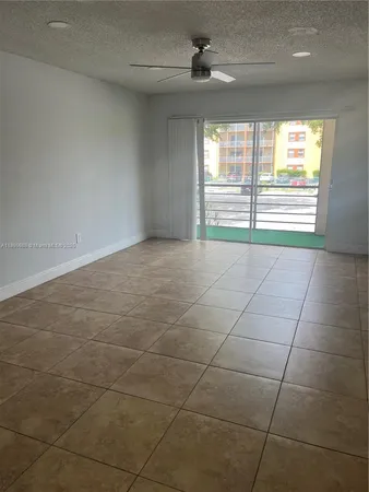a view of a room with a ceiling fan