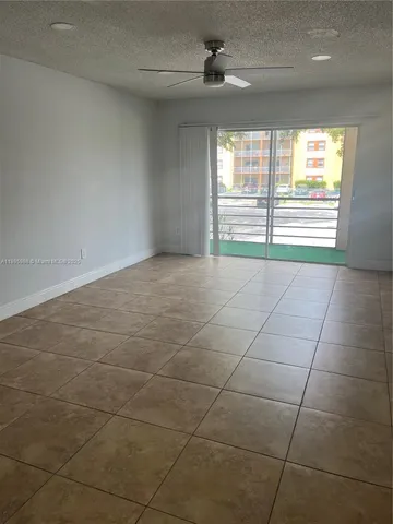 a view of a room with a ceiling fan